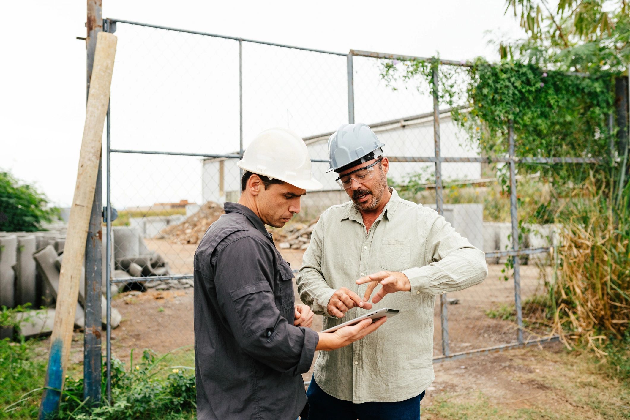 Construction professionals reviewing plans at a commercial project site